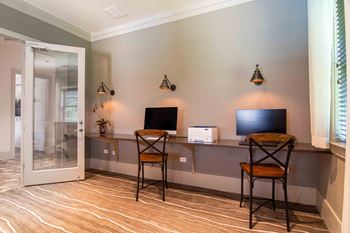 a room with a desk with two chairs and a television  at Century New Holland, Georgia